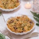 Shell shaped dish holding an individual serving of Shrimp and Crab Gratin