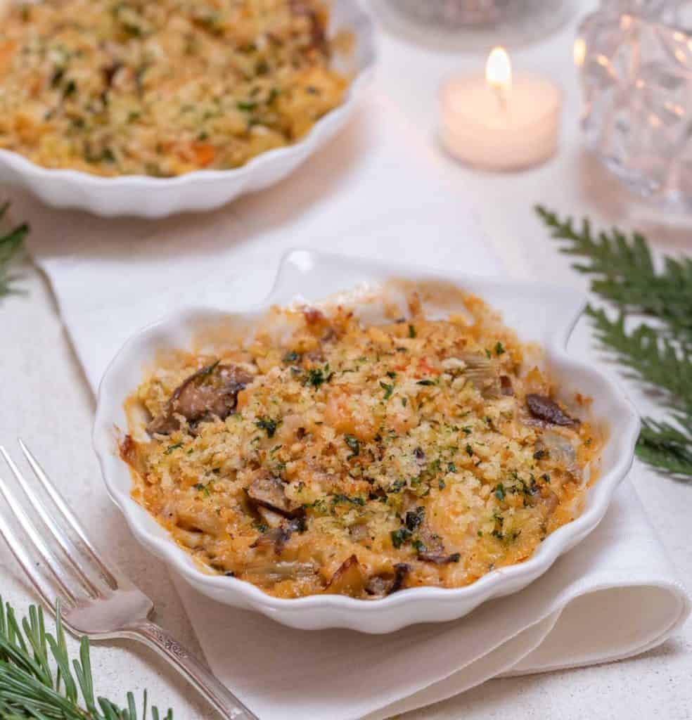 Shell shaped dish holding an individual serving of Shrimp and Crab Gratin