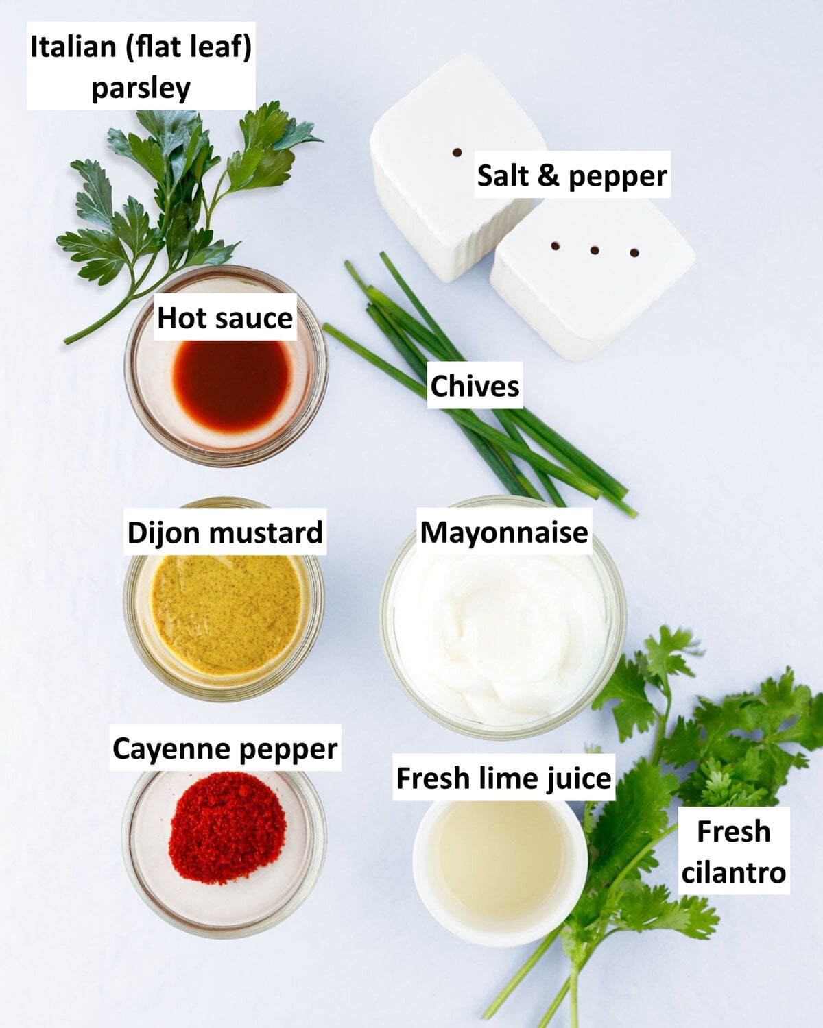 Ingredients to make spicy shrimp salad dressing in bowls on a table.
