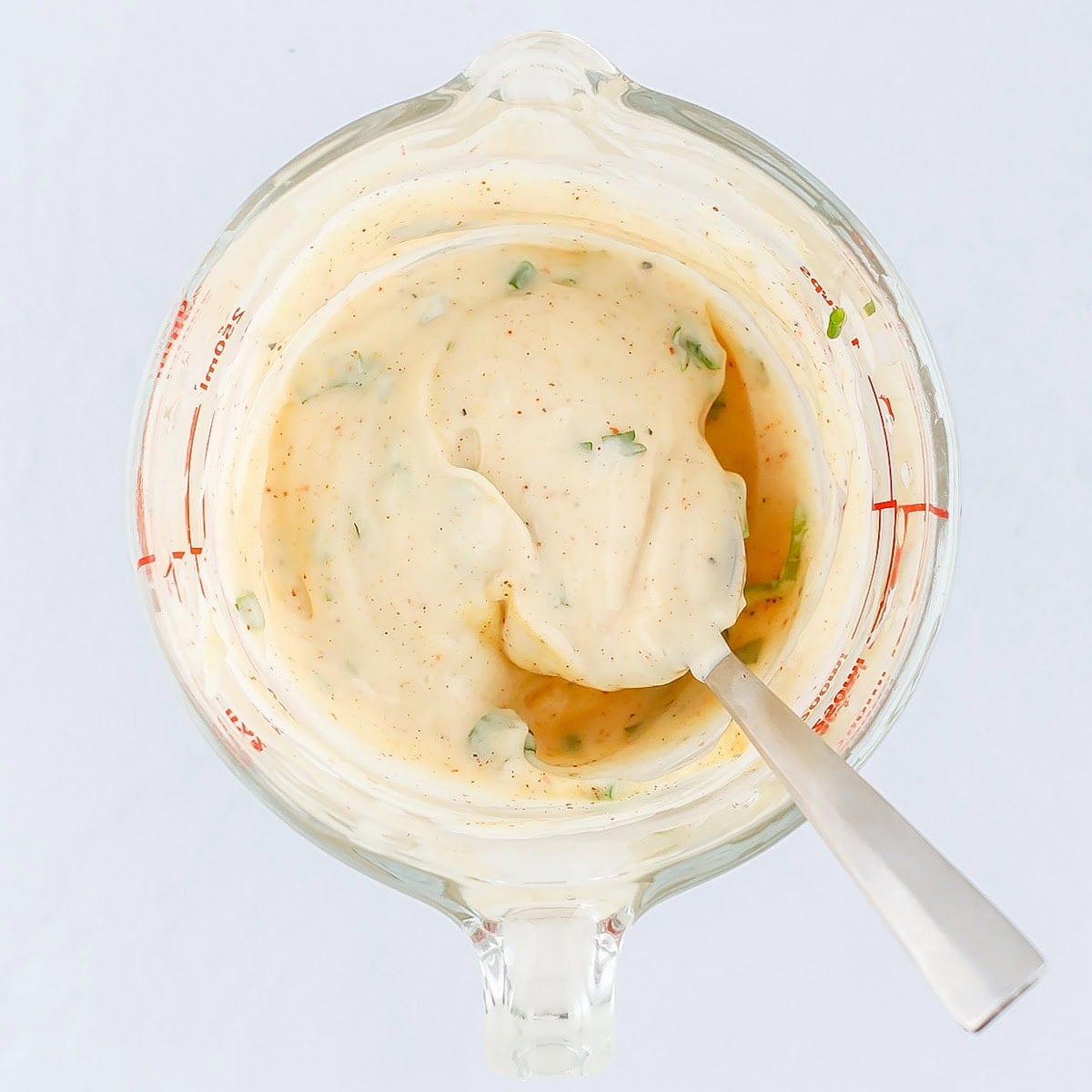 Mixing the ingredients for the dressing for shrimp salad in a bowl.