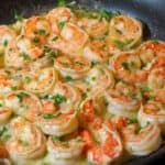 close up of shrimp scampi in a black skillet.