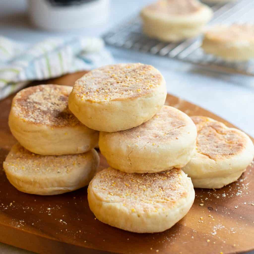 cutting board with a stack of Sourdough English Muffins