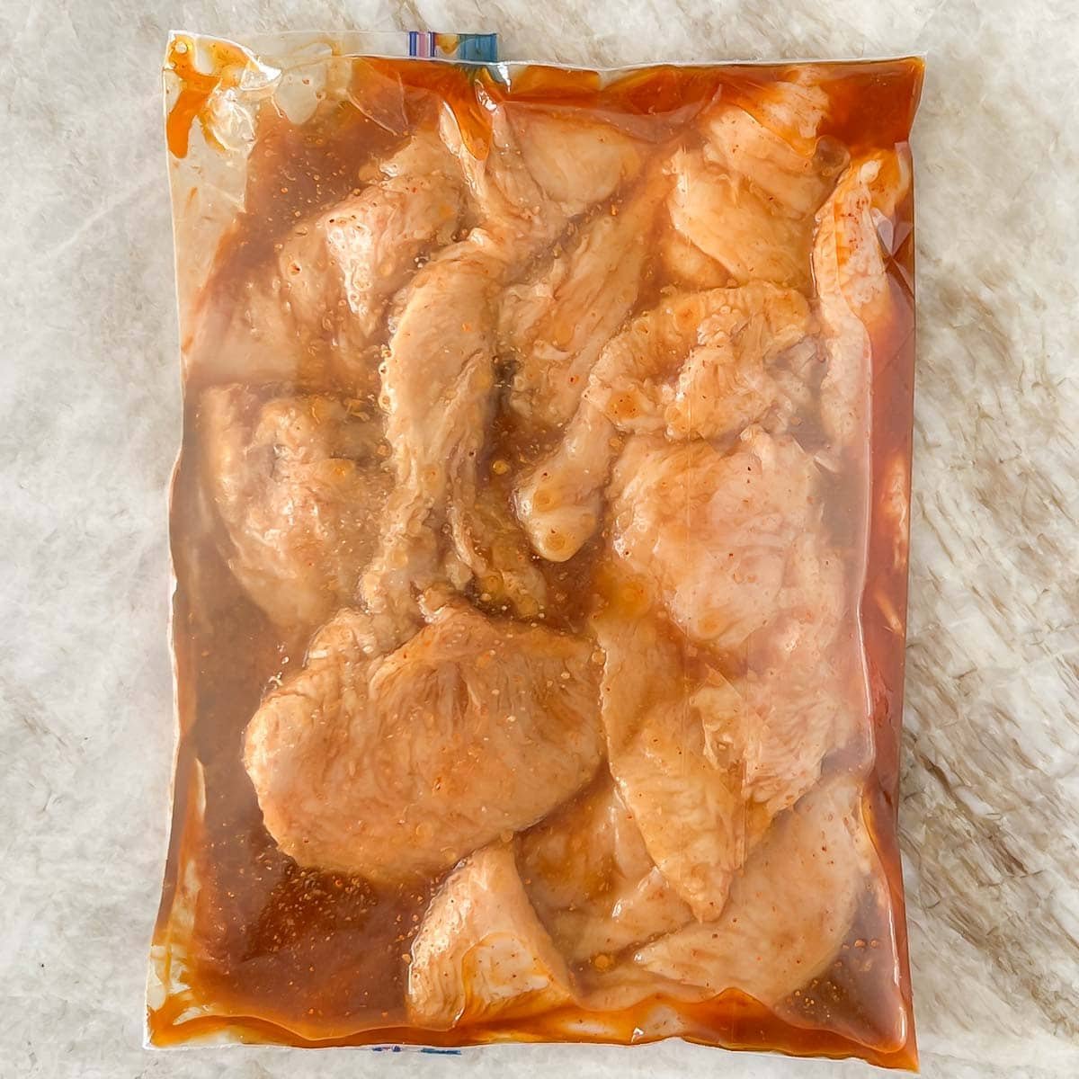 Chicken breasts in a baggie with marinade for Mexican Grilled Chicken.