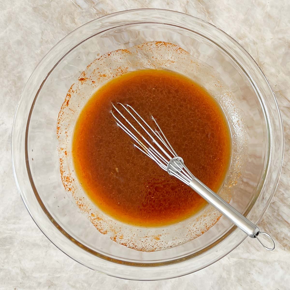 Mexican Grilled Chicken marinade in a mixing bowl.