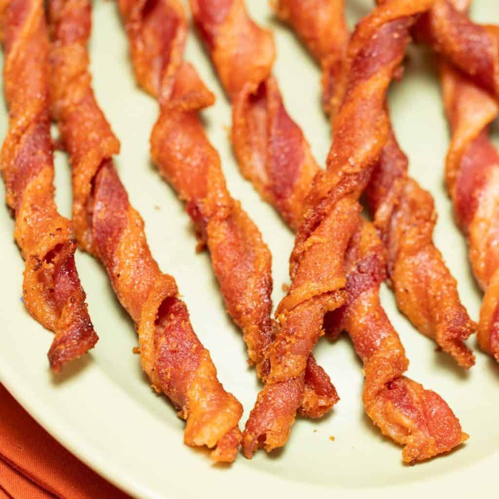 close up of oval platter filled with Spiced Bacon Twists