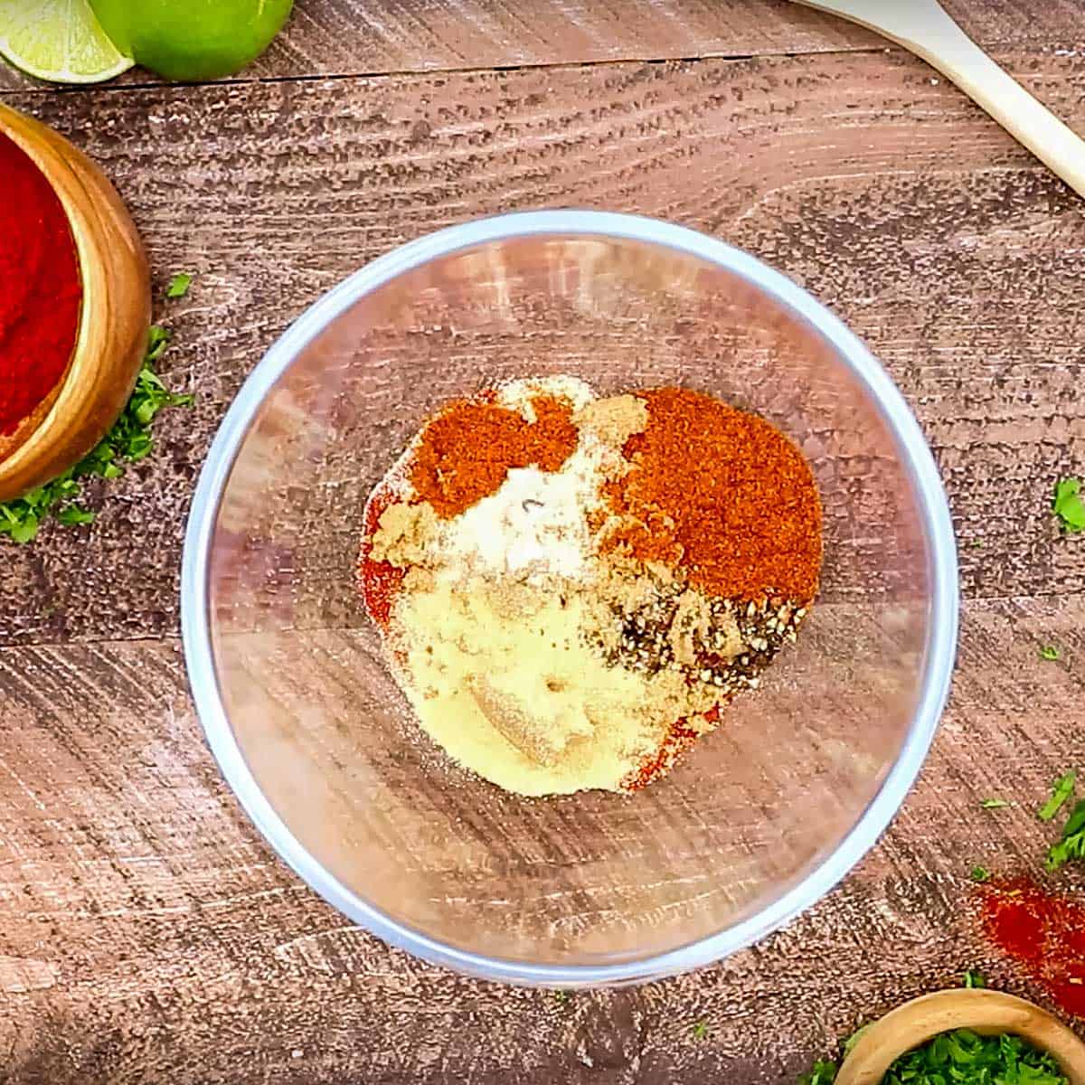 Glass bowl filled with spicy rub ingredients