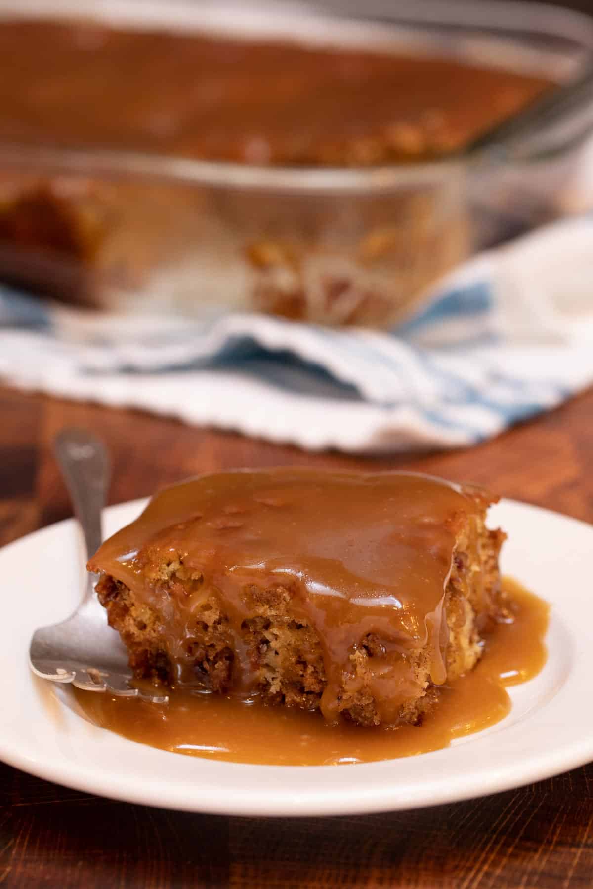 white plate with a slice of Sticky Toffee Pudding