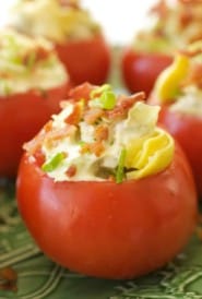 Green platter filled with Tomatoes Stuffed with Artichoke Hearts, Onions and Bacon