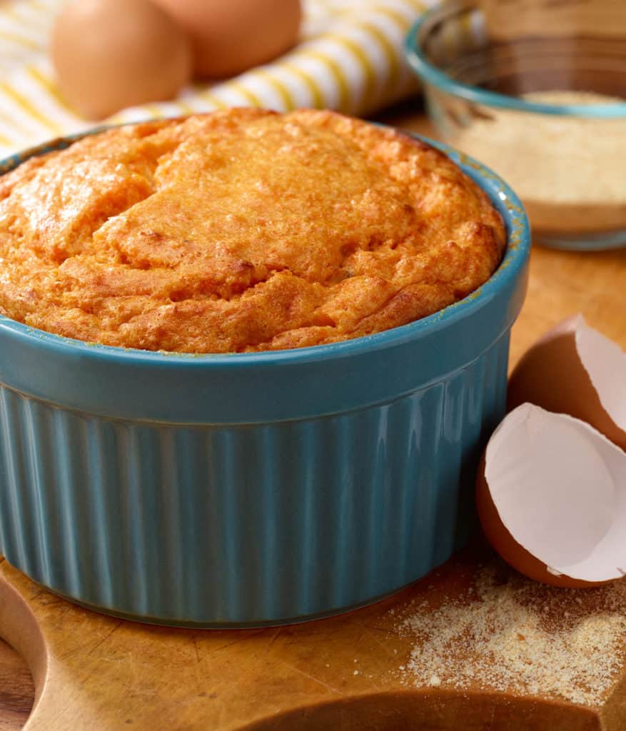 Blue souffle dish filled with Brandied Sweet Potato Souffle