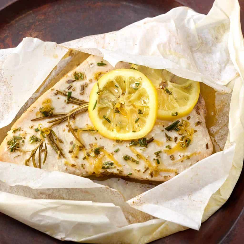 close up of cooked swordfish filet wrapped in parchment paper