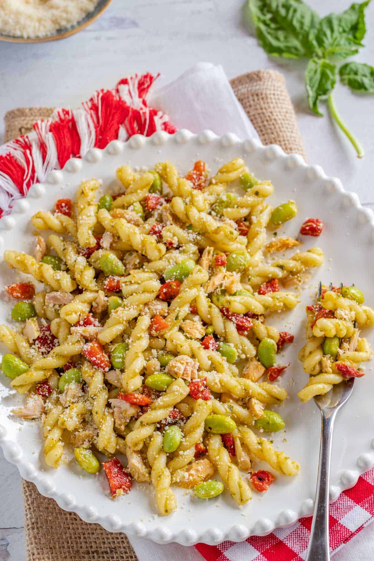 White plate filled with a portion of Tuna and Roasted Red Pepper Pasta Salad.