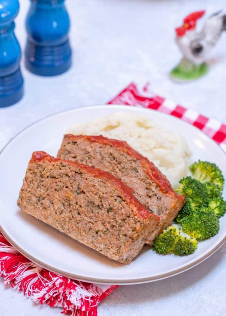 White plate showing a serving of Easy Turkey Meatloaf with mashed potatoes and broccoli