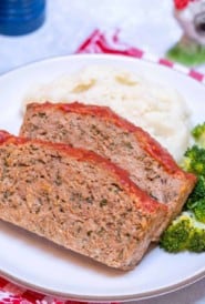 close up of white plate showing two slices of Easy Turkey Meatloaf, with mashed potatos and broccoli