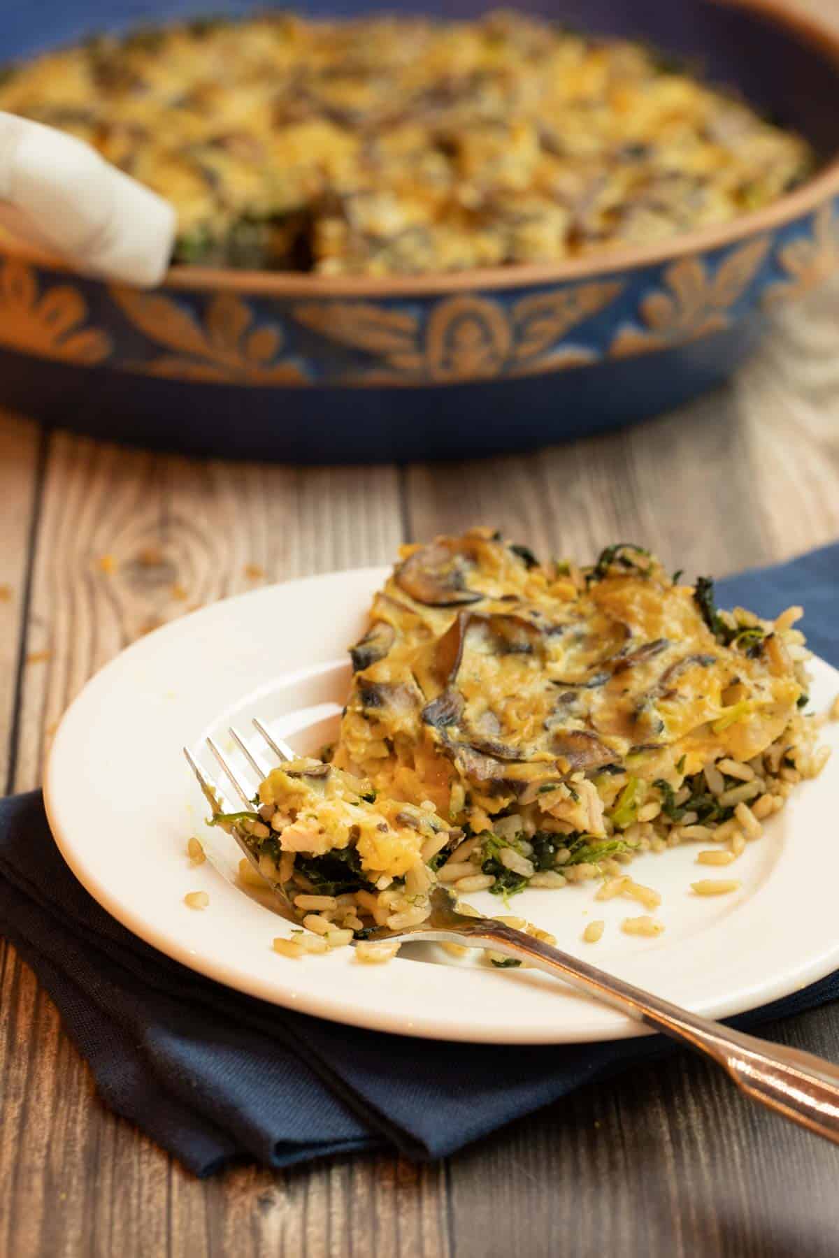 white plate with a slice of Turkey Mushroom Pie with Brown Rice-Spinach Crust