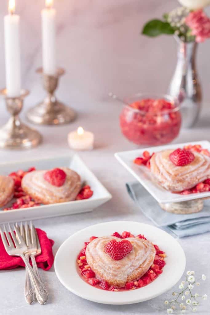 Three plates each holding a single Valentine's Mini Cake, with strawberry almond salsa on the side