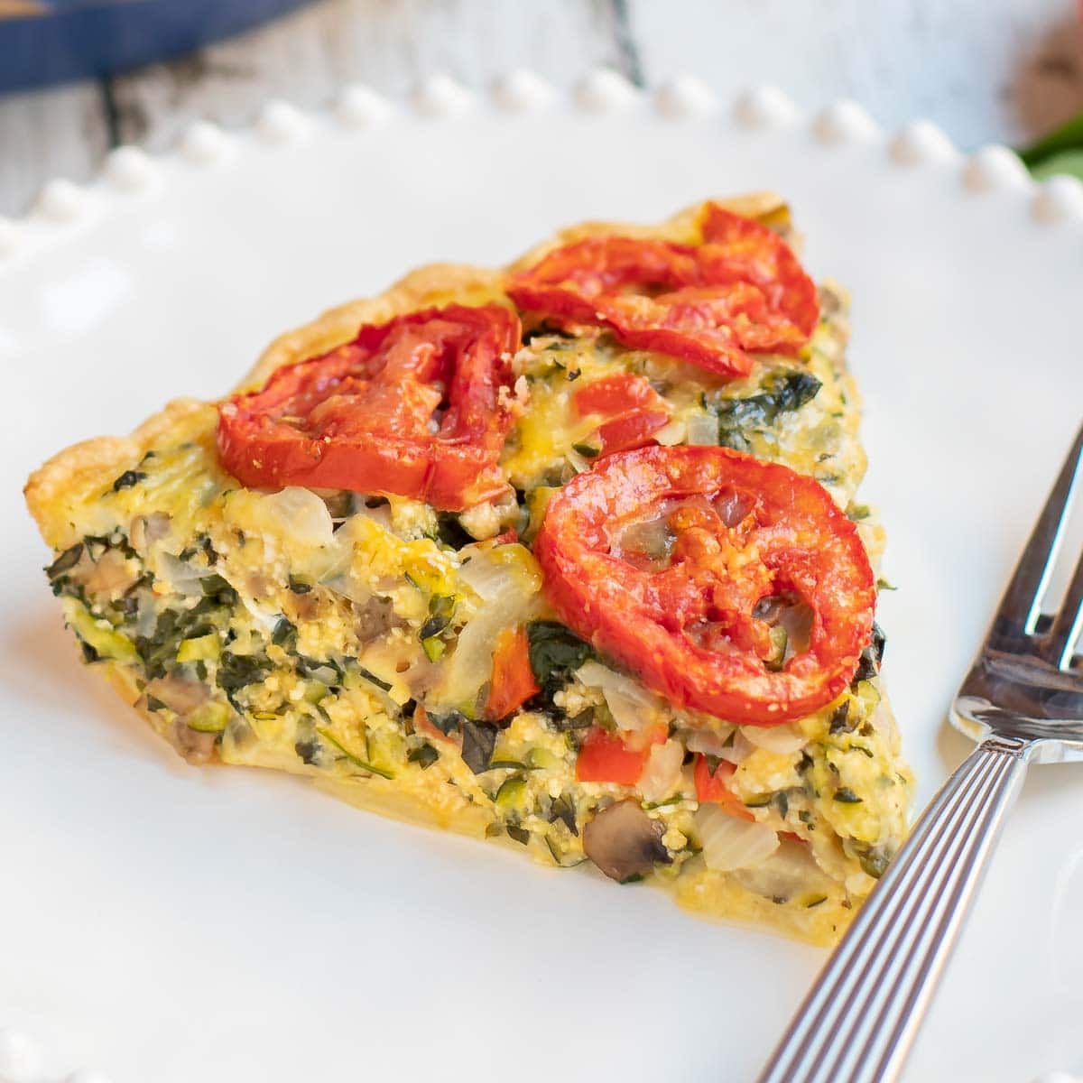 Close up of one slice of Garden Vegetable Quiche