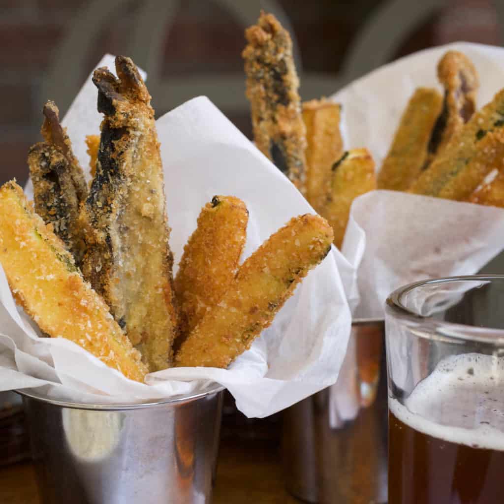 Siver cups filled with Veggie Fries in a napkin, with Lemon-Garlic Aioli on the side