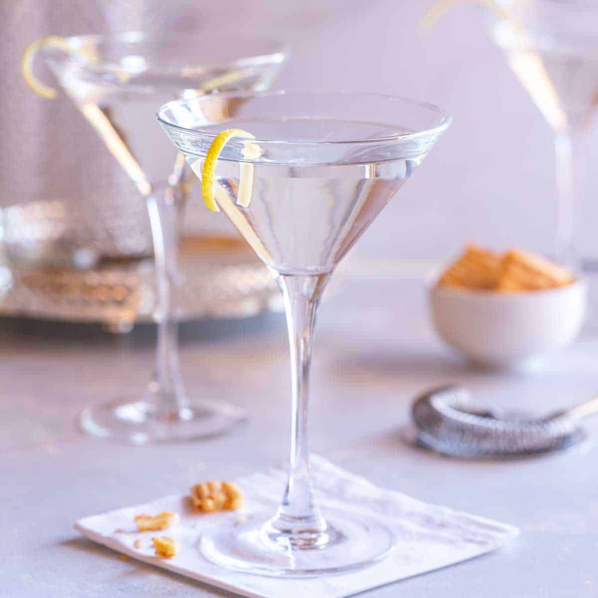 Martini glass filled with Vodka Martini with a Twist, with 2 more in the background
